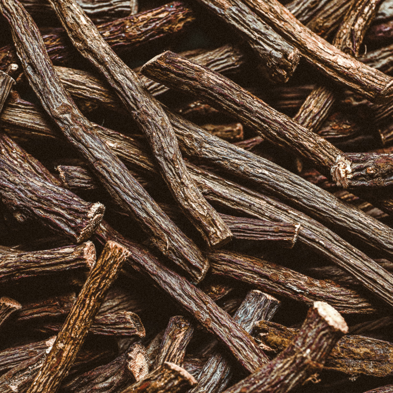 Dried sticks of liquorice root as background, top view
