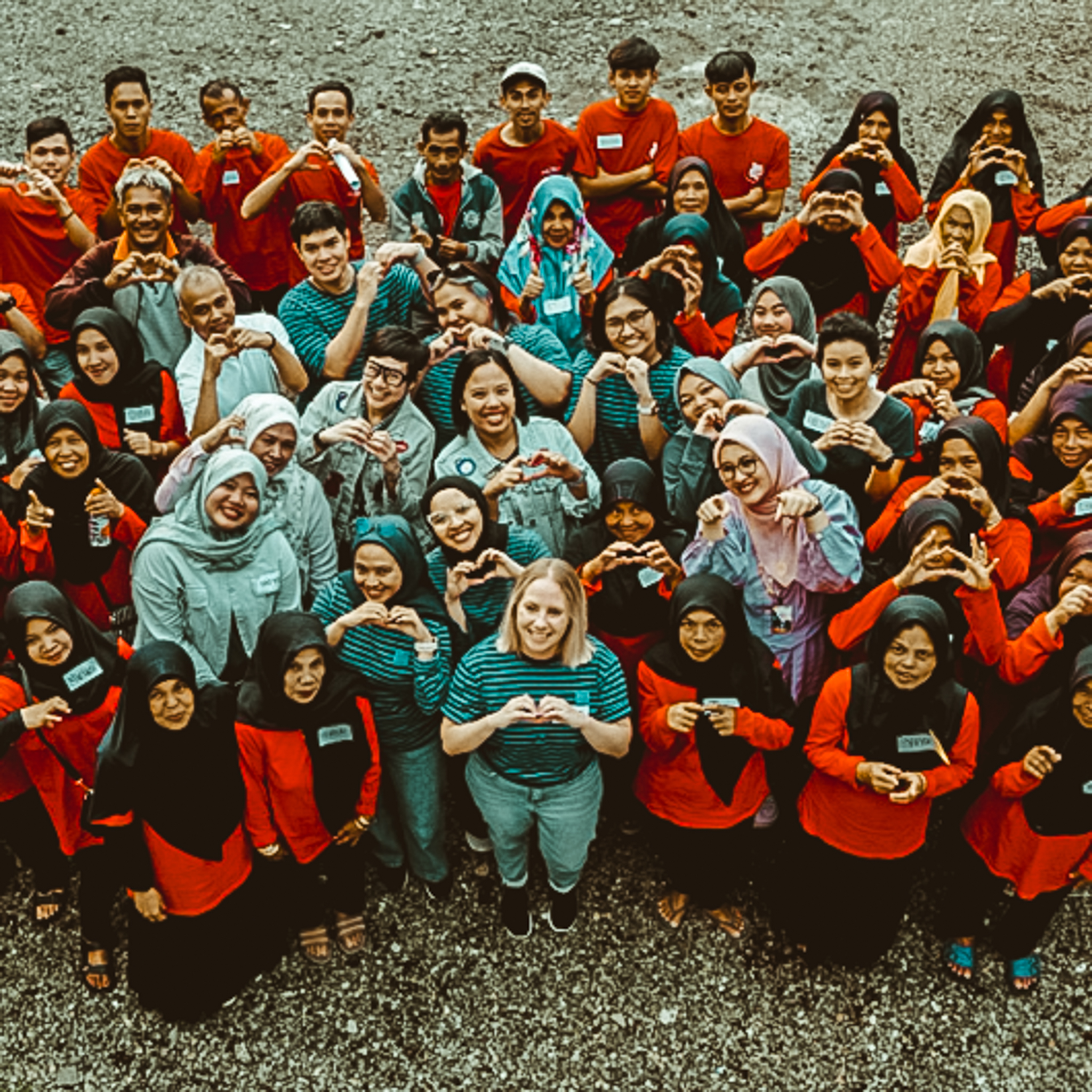 Team of our supplier in Indonesia, forming a heart shape with their hands
